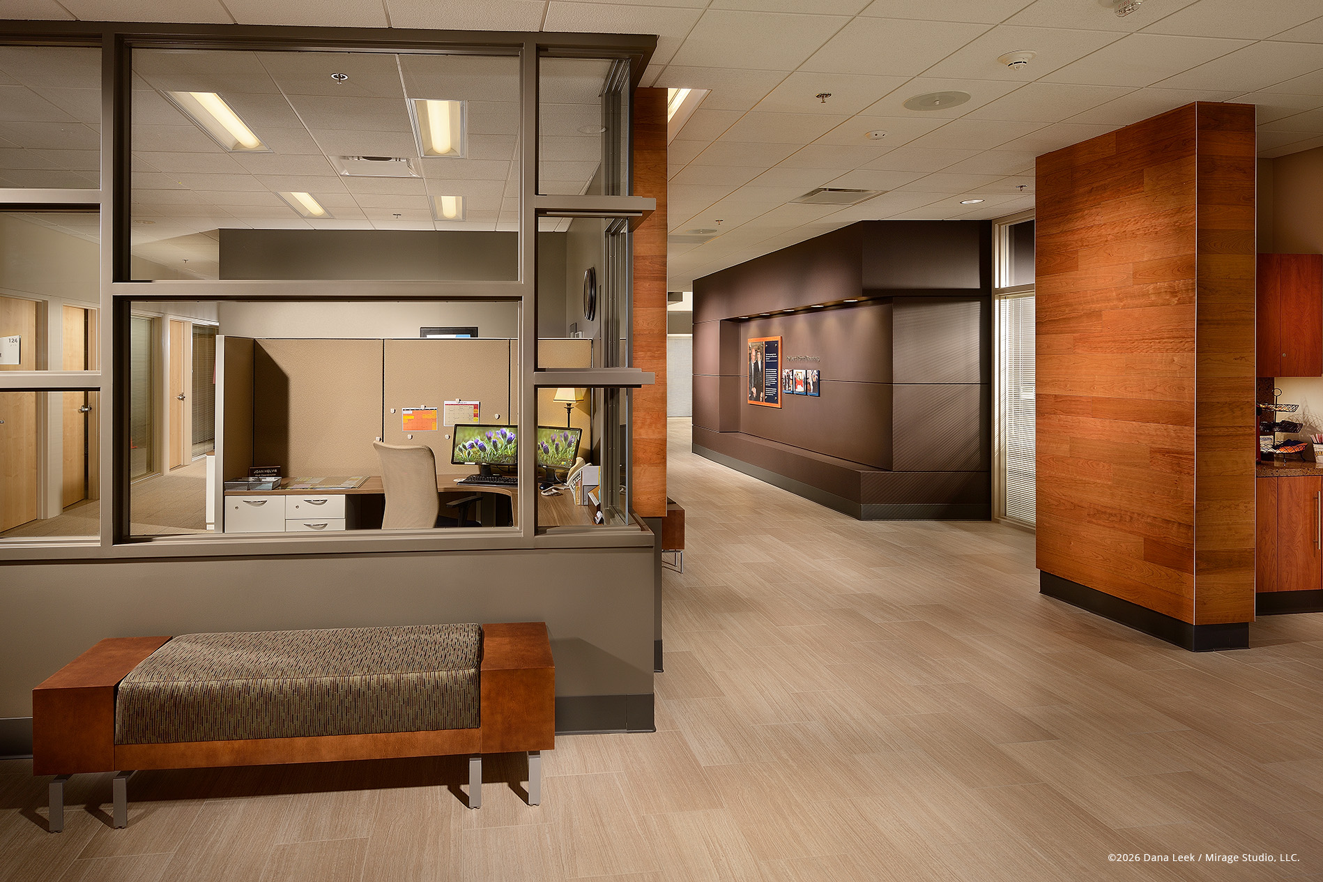 Admissions visit‑team workspace and corridor at the Duesenberg Welcome Center, photographed to showcase the warm wood accents and open workstation overlooking the main hall at Valparaiso University.